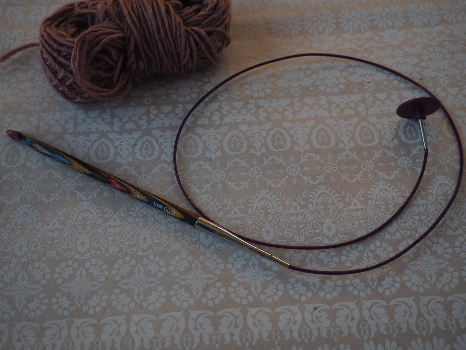 a tunisian crochet hook and yarn